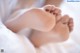 A close up of a baby's feet on a bed.